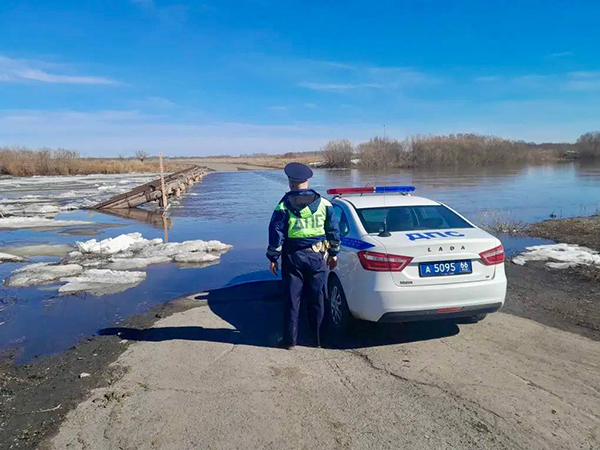 Сотрудник ДПС перед затопленным мостом в Свердловской области(2026)|Фото: Управле­ние Госавтоинспекции ГУ МВД России по Св­ердловской области